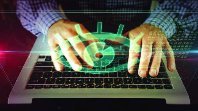 Hands using a laptop illustrating employee monitoring and workplace surveillance